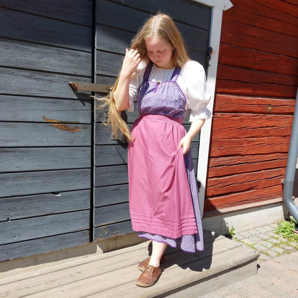 A long feresi dress with an apron and white blouse