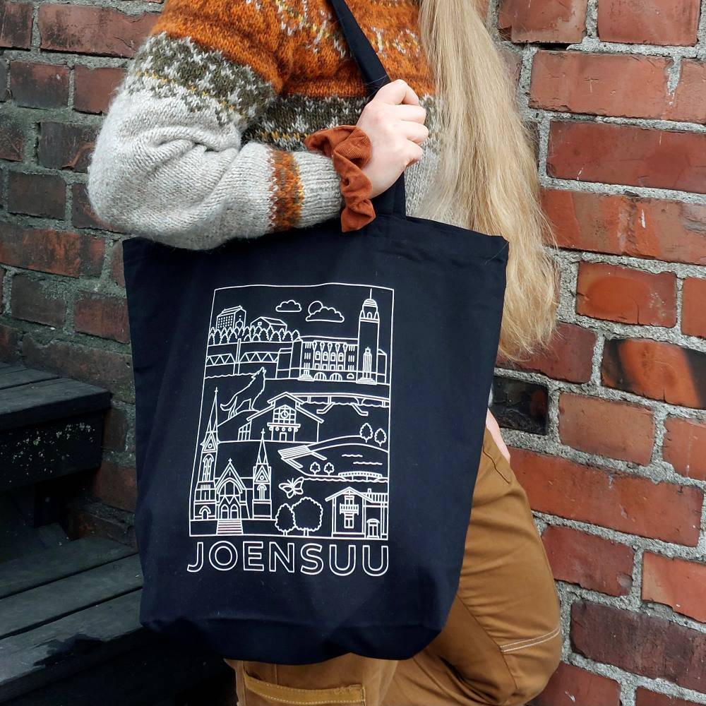 A black shopping bag with a modern city of Joensuu-pattern